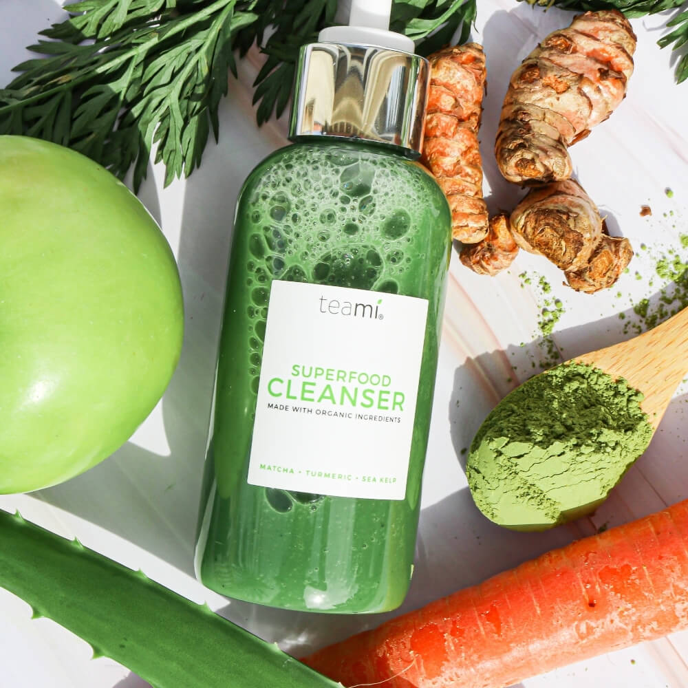 Teami skincare superfood cleanser lying on table of ingredients