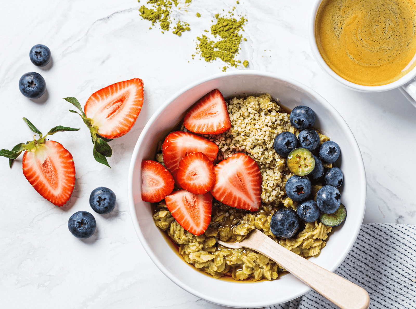 bowl of matcha oatmeal with blueberries and almonds