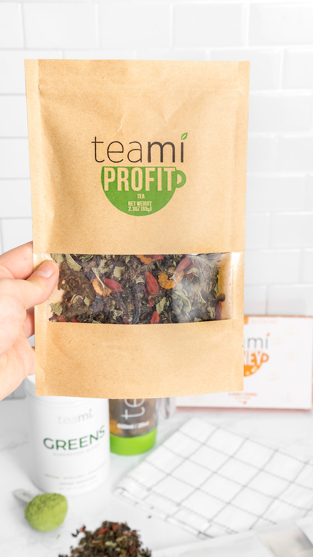 hand holding teami profit tea