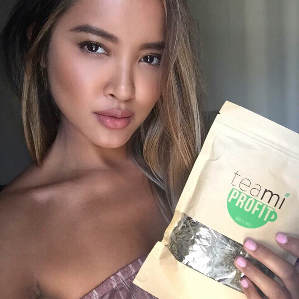 woman holding teami profit tea package