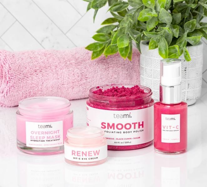 Teami Think Pink bundle products - overnight sleep mask, renew vit c cream, smooth body polish and vit c serum in bathroom