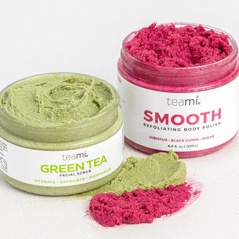 Teami down under green tea facial scrub and smooth body polish with lids off and contents on surface