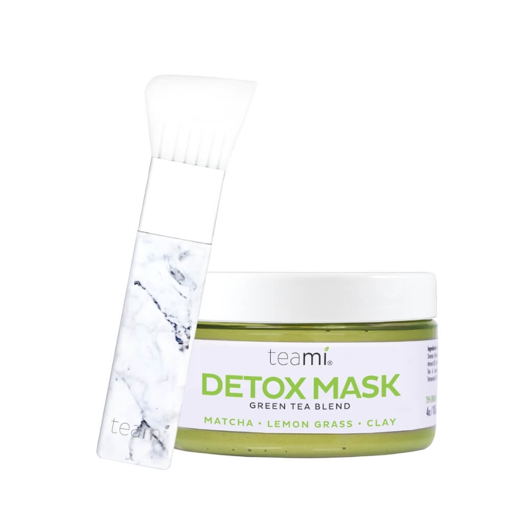Teami face mask applicator brush next to Detox mask on white background