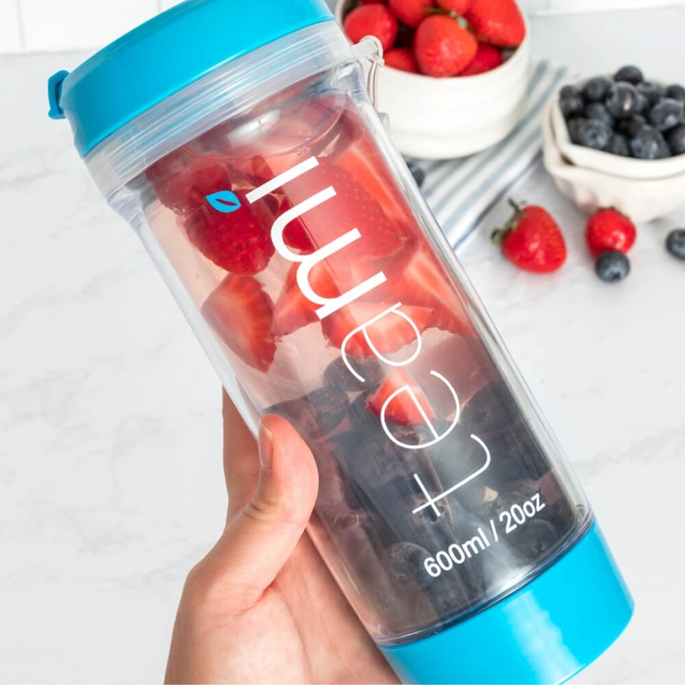 teami tea tumbler with strawberries and blueberries in it