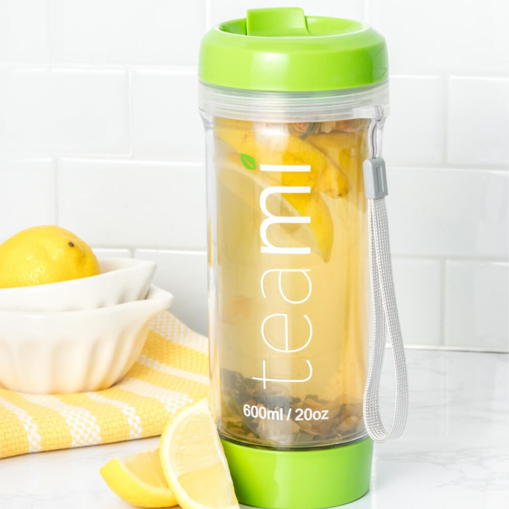 green teami tumbler with tea and lemon in it