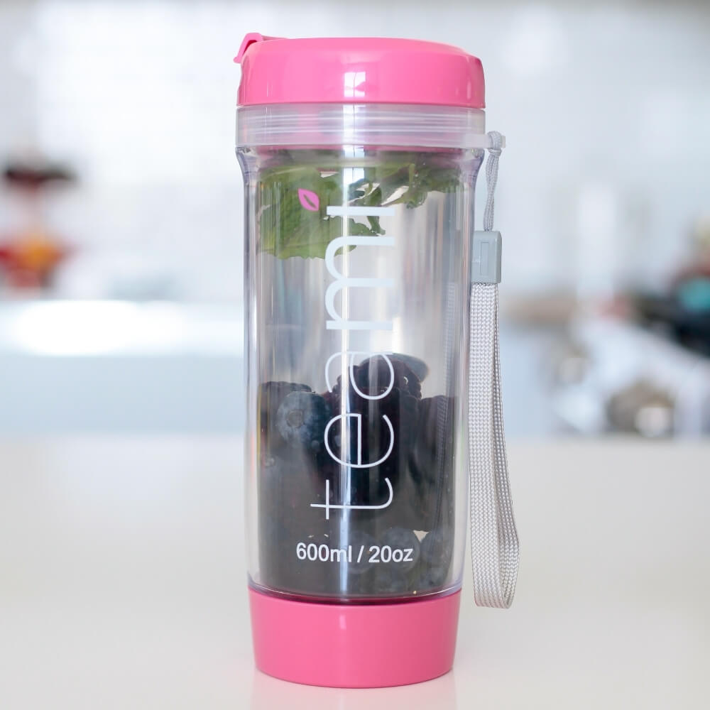 pink teami tea tumbler with blueberries inside
