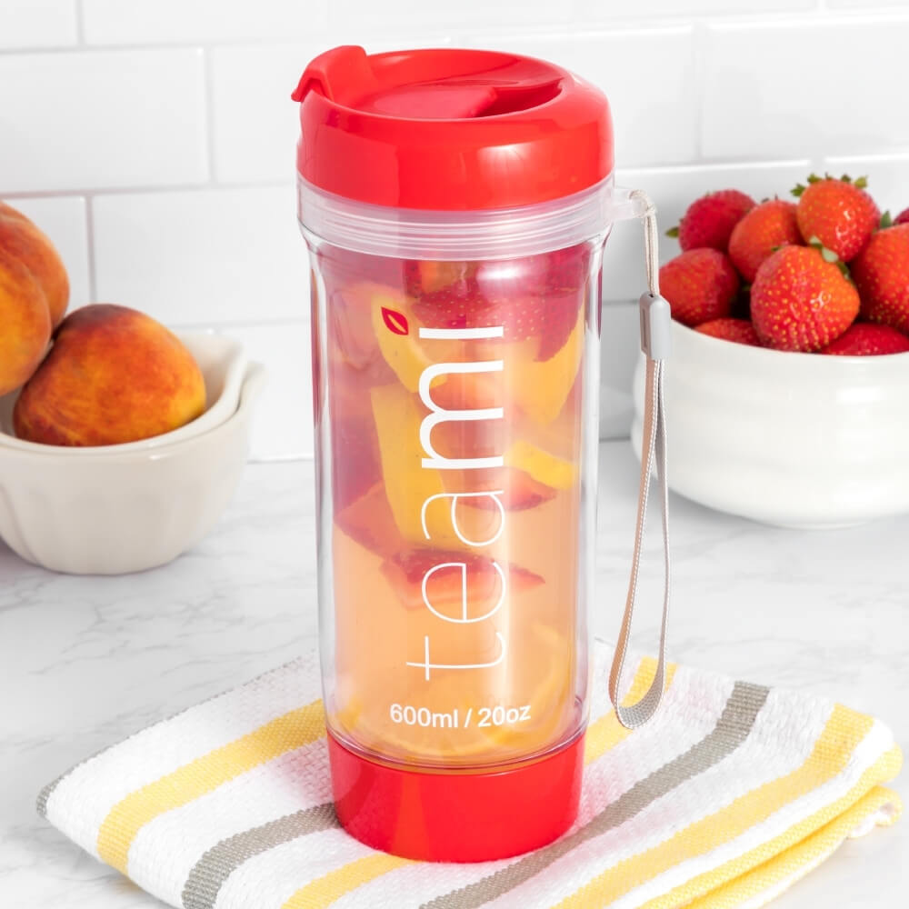 red teami tea tumbler with strawberries and peach inside