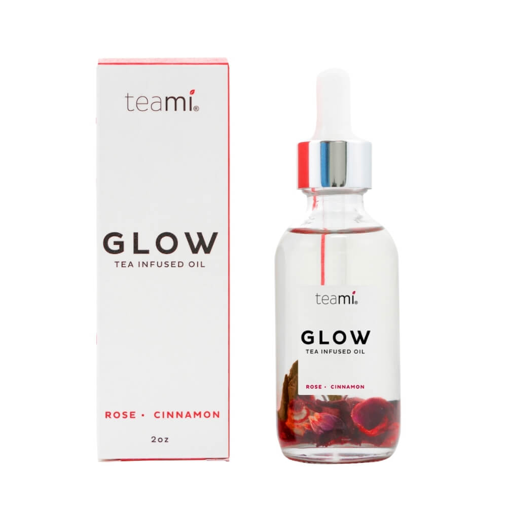 Teami glow oil with rose and cinnamon next to packaging