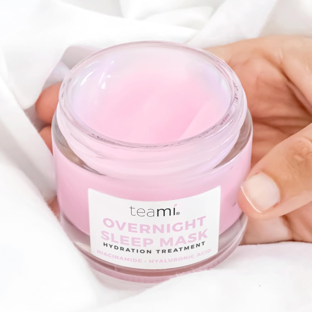 Hand holding Pot of Teami overnight sleep mask with lid off