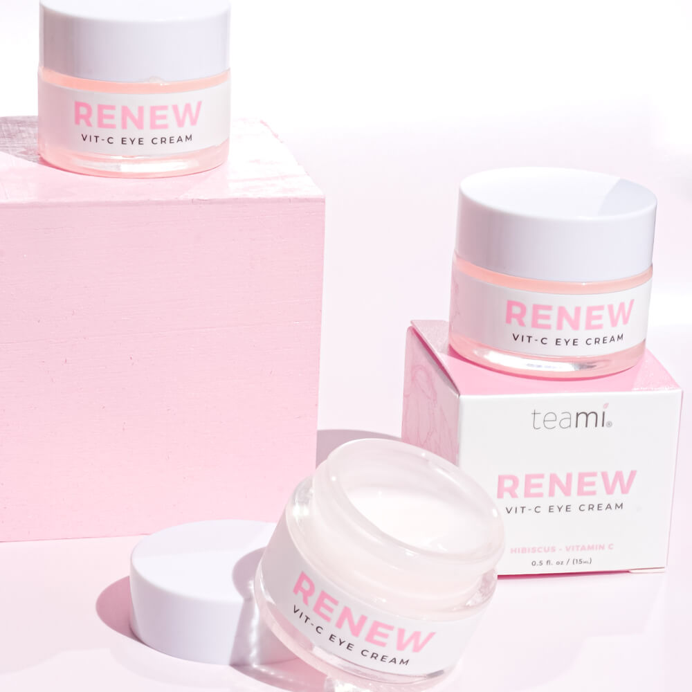 Multiple pots of Renew Vit C eye cream on pink background