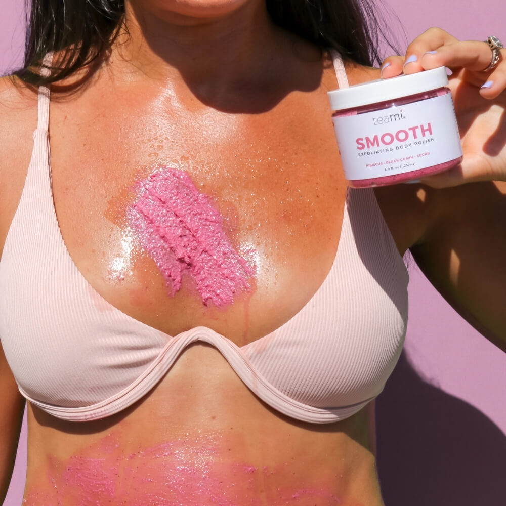 Women with Teami smooth product on her chest and holding pot of Teami Smooth product