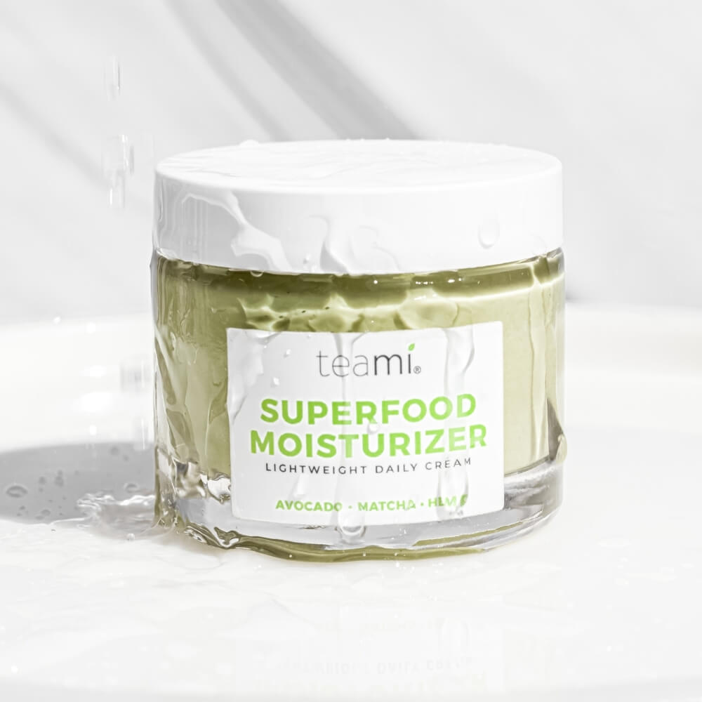 Pot of Teami superfood moisturizer cream with water on 