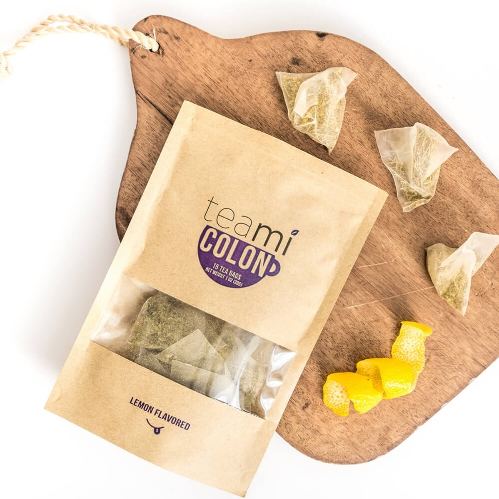 lemon flavoured teami colon tea on a cutting board next to lemon zest