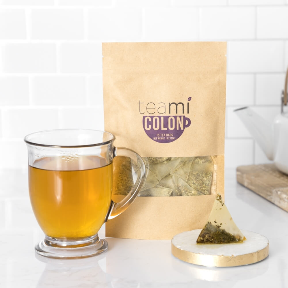 teami colon tea next to cup of brewed tea and the tea bag