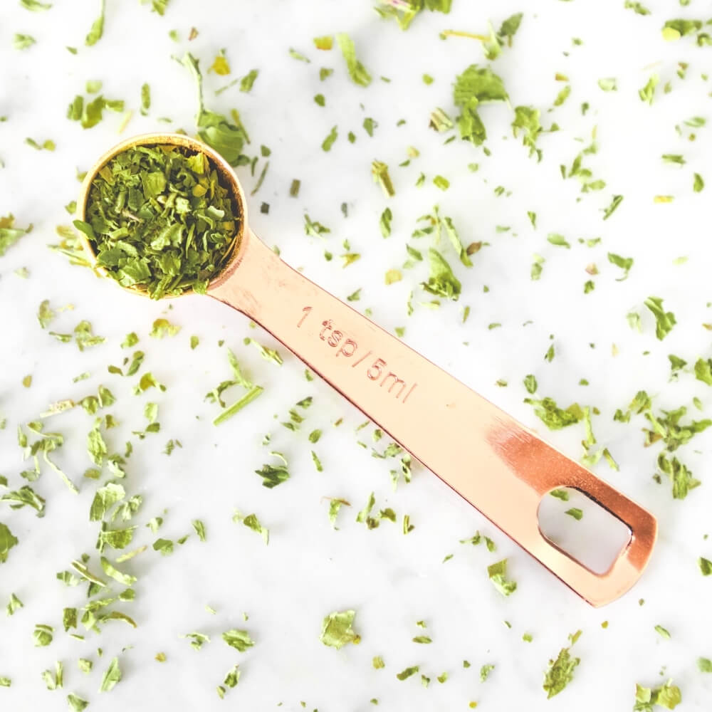 copper spoon with Teami boost tea leaves