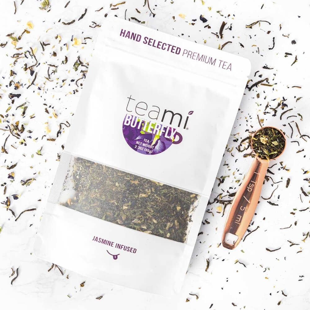 teami butterfly tea package next to a copper tea measurer