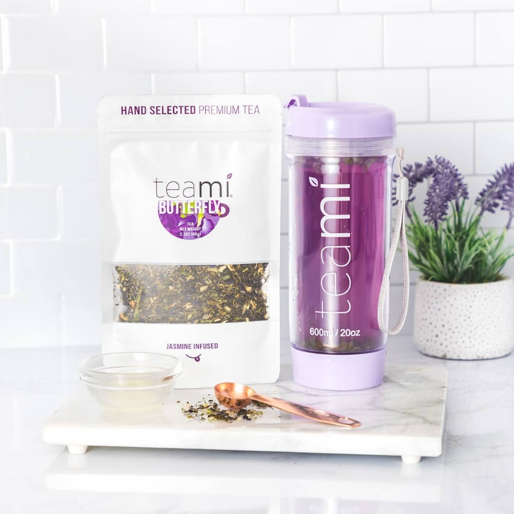 teami butterfly tea and teami tumbler on a counter
