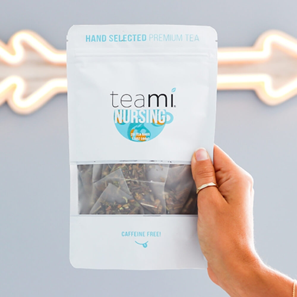 Person holding pack of Teami nursing tea blend