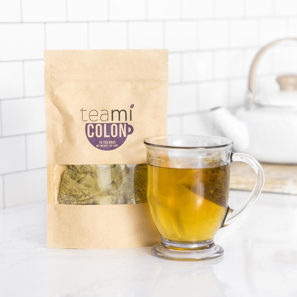 teami colon tea package next to brewed cup of tea