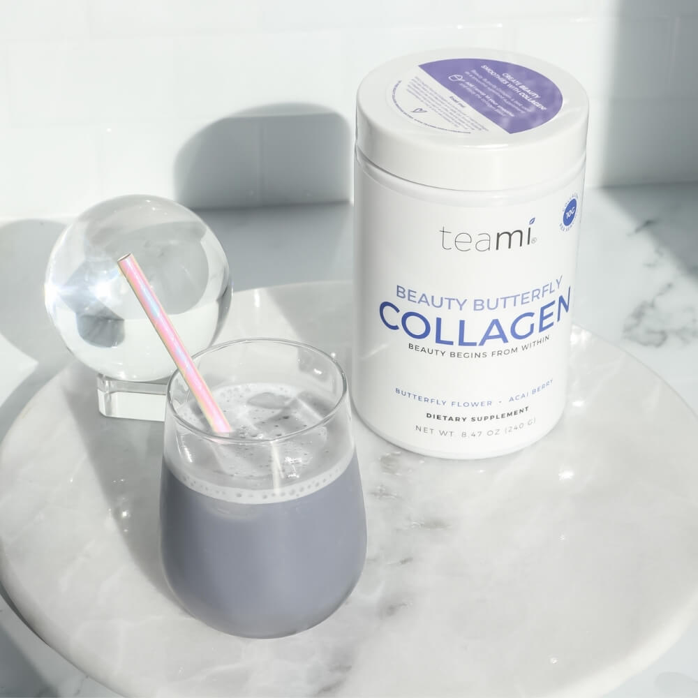 tub of Teami beauty butterfly collagen next to glass of drink